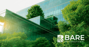 Eco-friendly corporate building with glass architecture and greenery, representing authentic ESG and sustainability efforts – BARE International