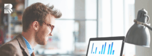 Professional reviewing customer satisfaction metrics on a laptop, representing mystery shopping insights and performance analysis.